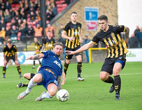 Martin Scott in action during the tie at Beechwood Park.