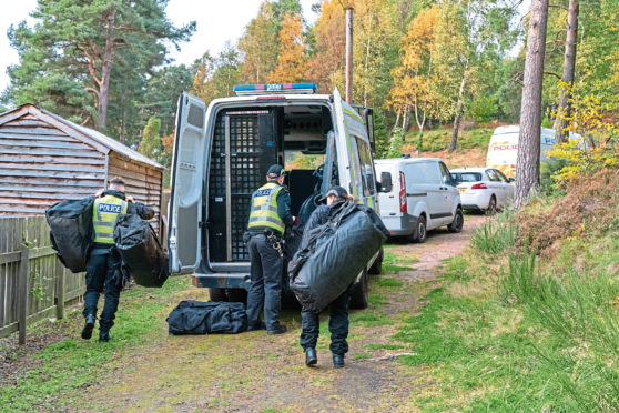 Police at the scene in
Birkenhill Woods