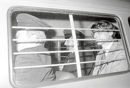 Dennis Nilsen, right, with a prison warden at his side, after he was sentenced to a minimum of 25 years imprisonment after being convicted of six murders and two attempted murders at the Old Bailey