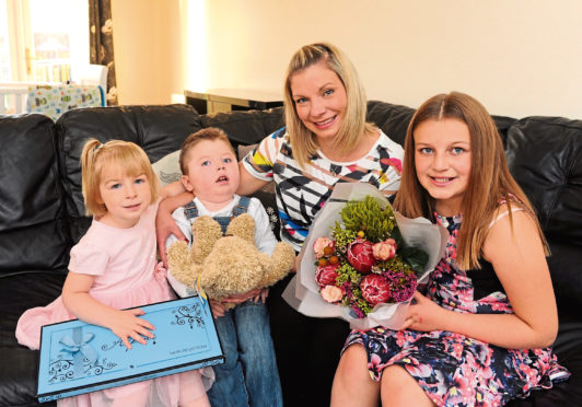 Jack Walker with mum Shelley and sisters Eve-Rose and Ruby pictured in 2014 after winning the EE's Happy Tots competition