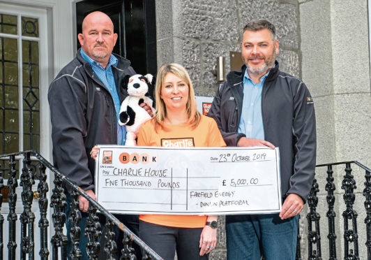 Alan Reid and Doug McFarlane presenting a cheque to Kirsty Walker of Charlie House