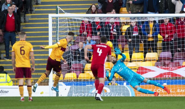 Aberdeen's Joe Lewis is pictured saving Motherwell's James Scotts's penalty at Fir Park.