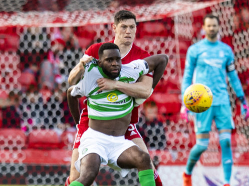 Back in action for the Dons, Scott McKenna grapples with Celtic's Odsonne Edouard during the Ladbrokes Premiership match between Aberdeen and Celtic.