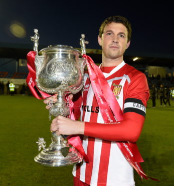 Formartine United captain Stuart Anderson with the Evening Express Aberdeenshire Cup after their 2017 success