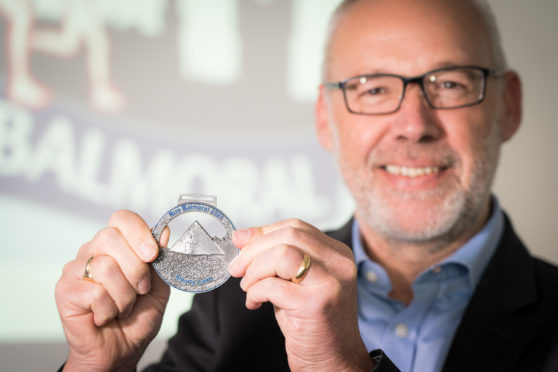 Jonathon White of duathlon sponsors Apollo with 2020 Run Balmoral medal.