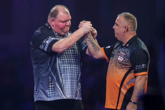 John Henderson wins his second round match against James Richardson during the PDC William Hill World Darts Championship at Alexandra Palace, London.