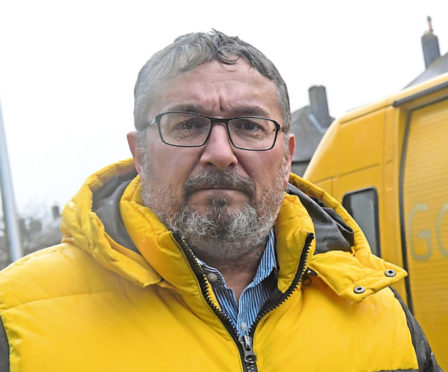 Councillor Christian Allard has worries for the fish market's future - him in front of a french registered van with racist abuse on it