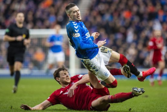 Ash Taylor tackles Ryan Kent during Aberdeen's 0-0 draw with Rangers at Ibrox