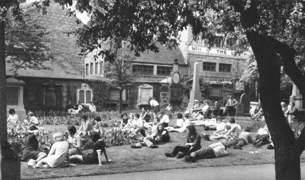City workers make the most of the sunshine during their lunch-hour in St Nicholas churchyard