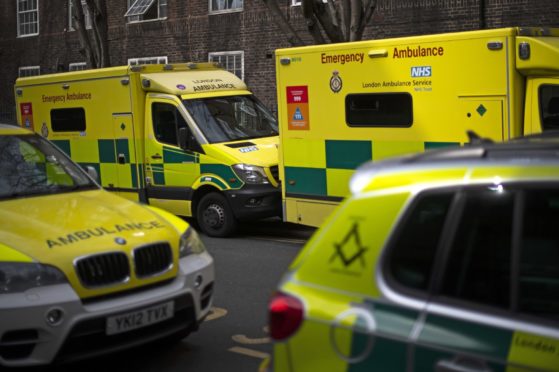 London ambulances line a street in Westminster, London as the UK continues in lockdown to help curb the spread of the coronavirus