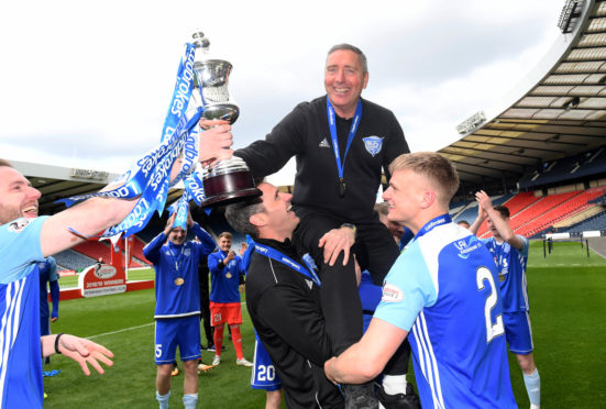 Peterhead manager Jim McInally lifts the Ladbrokes League 2 trophy.