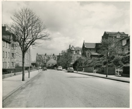 A quiet Grampian Road in Torry, featuring only a few parked cars, pictured in 1973