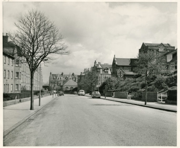 A quiet Grampian Road in Torry, featuring only a few parked cars, pictured in 1973