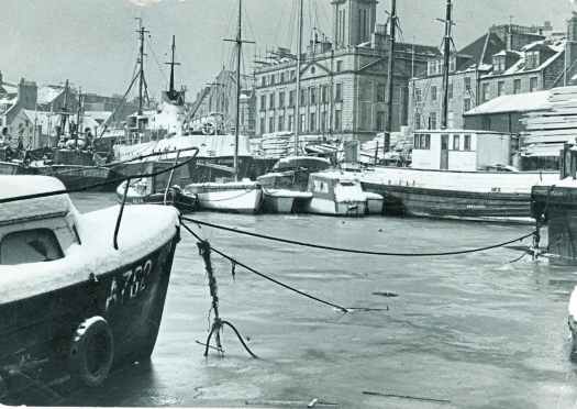 A wintry scene at Regent Quay, beside the harbour board building