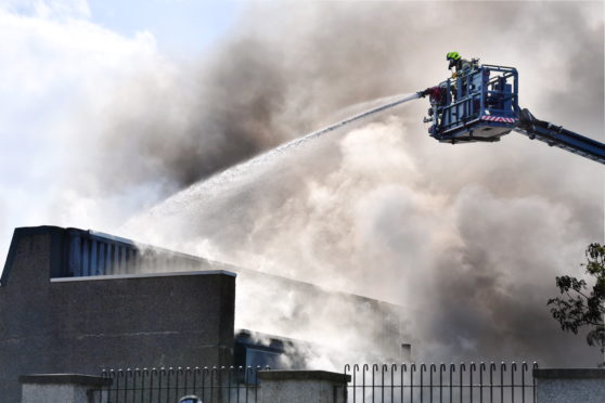 Firefighters tackle the blaze at Byron Square. Picture by Kami Thomson