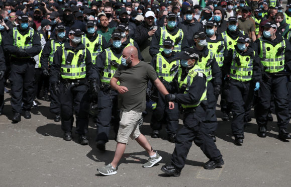 Protesters are escorted by police from George Square in Glasgow city centre after a Glasgow Says No to Racism event aimed at "sending a positive anti-racist message from Glasgow's George Square to the world on World Refugee Day".