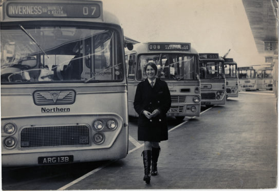 1974: A smiling 'clippie' at Guild Street bus station is glad to be back at work in 1974 after a dispute was settled and picketing ended.