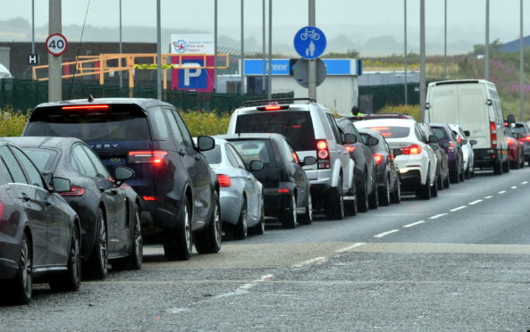 Cars queuing outside the coronavirus testing centre at Aberdeen Airport. Picture by Chris Sumner