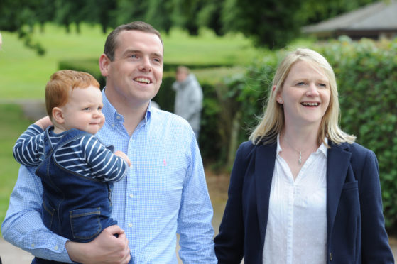 Douglas Ross with wife Krystle and son Alistair in Grant Park, Forres after being appointed leader of the Scottish Conservatives today.