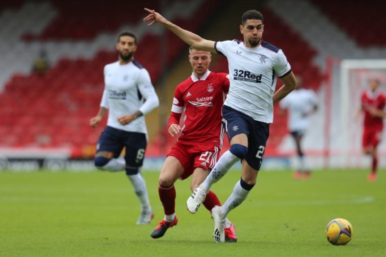 Leon Balogun of Rangers holds off Aberdeen forward Bruce Anderson.