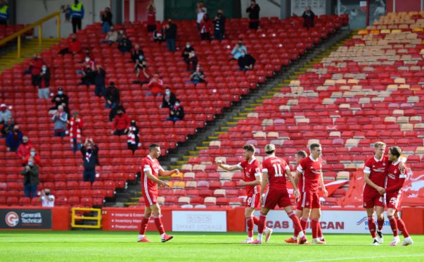 Aberdeen players and fans celebrate Ross McCrorie's goal against Kilmarnock.