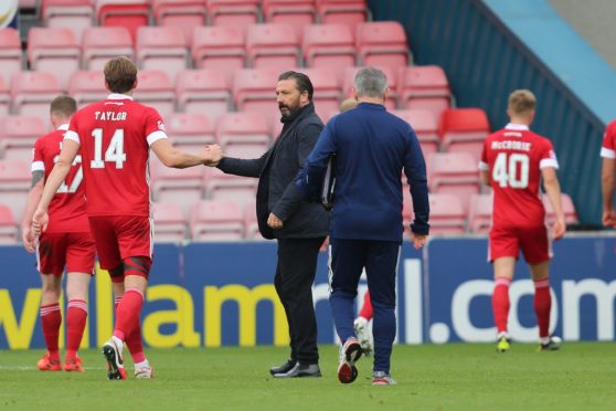 Derek McInnes shakes hands with his players after the game in Dingwall.