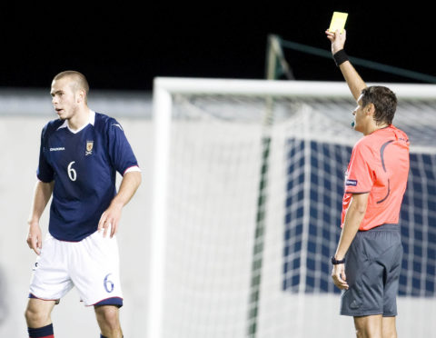Andy Considine is booked for Scotland Under-21s against Slovenia in 2008.