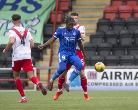 Isaac Layne of Peterhead challenges for the ball with Callum Fordyce of Airdrie.