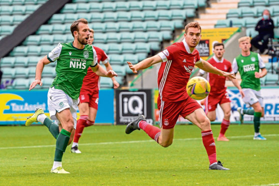 Hoban, right, shields the ball from Christian Doidge of Hibs.