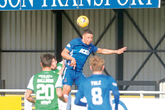 Leighton McIntosh goes up for a header against Hibs.