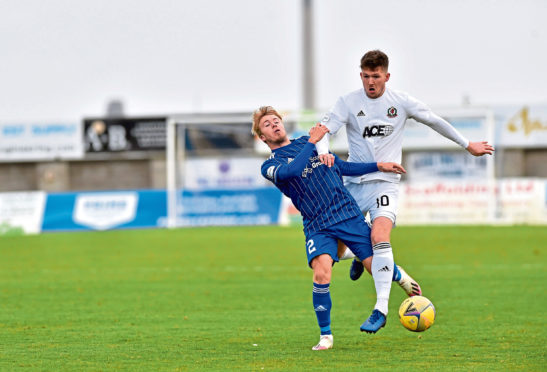 Kieran Freeman and Jamie Masson challenge for the ball.
Picture by Scott Baxter