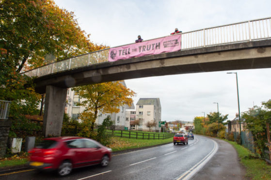 The banner was attached to a footbridge over the A96 Aberdeen to Inverness road in Elgin. Picture by Jason Hedges.