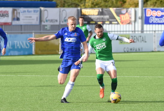 Harry Milne goes up against Martin Boyle during Cove Rangers' Betfred Cup tie with Hibernian.