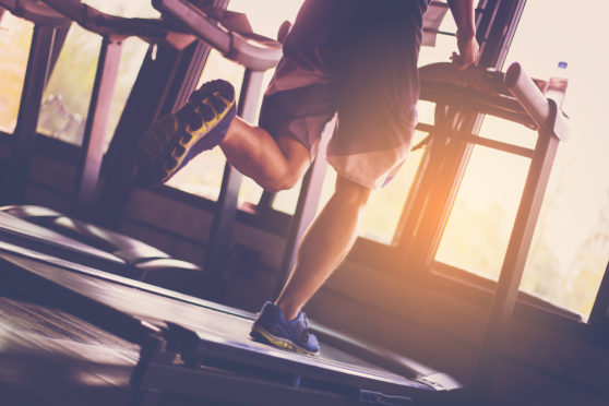 A woman works out on a treadmill.