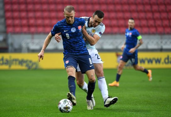 Slovakia's Ondrej Duda (left) and Scotland's Andy Considine battle for the ball.