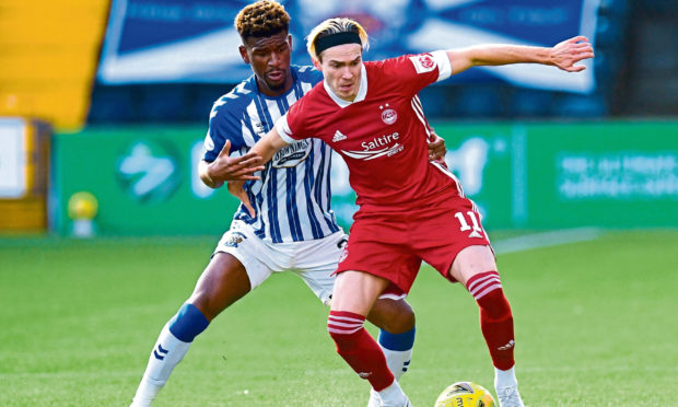 Aberdeen's Ryan Hedges (R) holds off Kilmarnock's Aaron Tshibola.