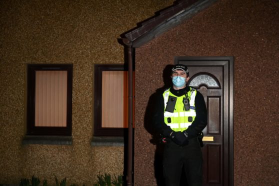 A police officer stands guard outside the property in Cove's Allison Close after the body of Christina Malley was found.
