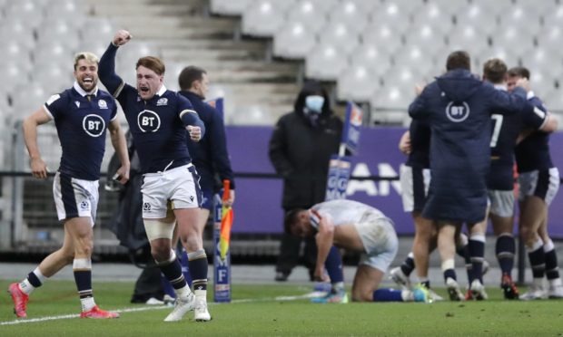 Scotland's Stuart Hogg, second left, celebrates after Scotland's Duhan Van der Merwe scored the winning try during the Six Nations rugby union international match between France and Scotland at the Stade de France.