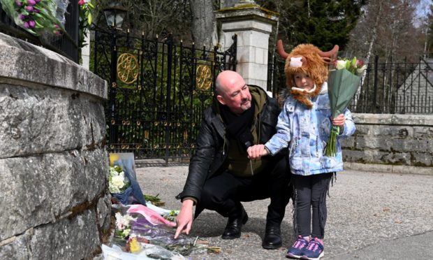Floral tributes left at the Balmoral Castle front gate in memory of the late Duke of Edinburgh, Prince Philip.
Pictured are Steve Mitchell and daughter Constance, 4.