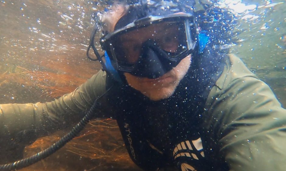 Beau swimming in the River Arkaig shortly before discovering the pineapple grenade which put filming on hold and sparked a call to the bomb squad.