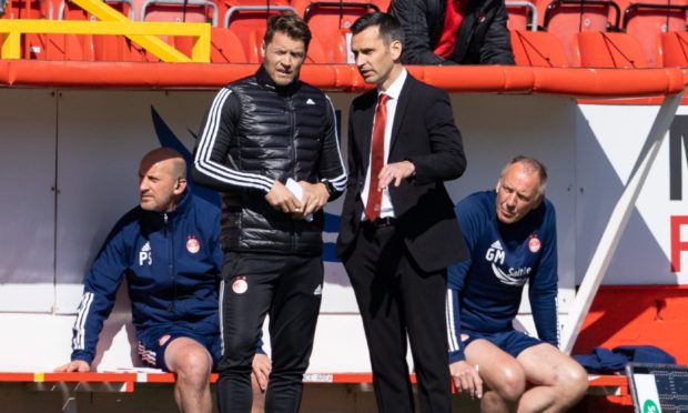 Aberdeen manager Stephen Glass talks with coach Allan Russell.