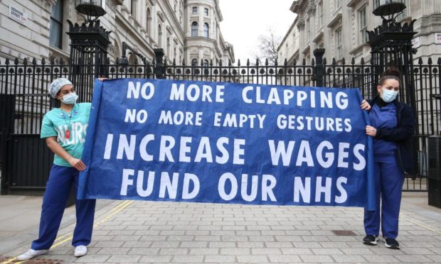 Nurses and NHS workers hold a socially distanced protest outside Downing Street in London. Unison says half of Scotland's nurses have contemplated quitting.