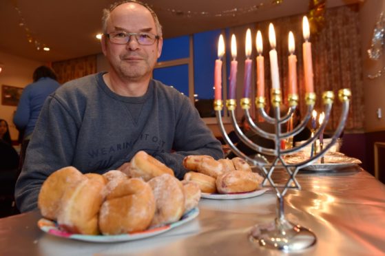 The Jewish community in Aberdeen are unable to have their Hanukkah celebration at their synagogue this year as its still closed due to flood damage. The congregation of Summerhill Church have kindly let them use their hall this year for their festivities.
Picture of Mark Taylor (head of Aberdeen Synagogue) with the Menorah.
Picture by KENNY ELRICK 17/12/2017
