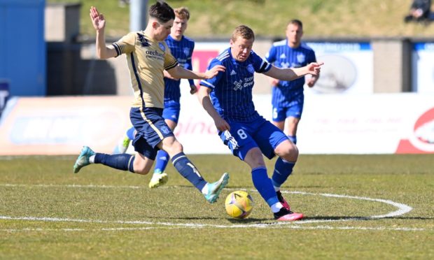 Scott Brown, right, tries to evade Callum Moore