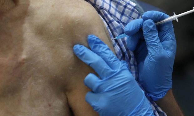 A nurse administers the Pfizer/BioNTech Covid-19 vaccine.