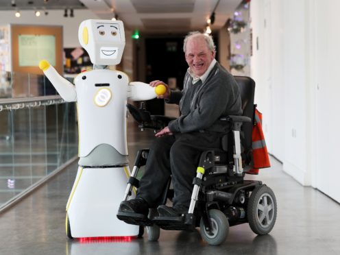 Ireland’s first socially assistive AI robot ‘Stevie II’ from robotics engineers at Trinity College Dublin, with Brendan Crean (Brian Lawless/PA)