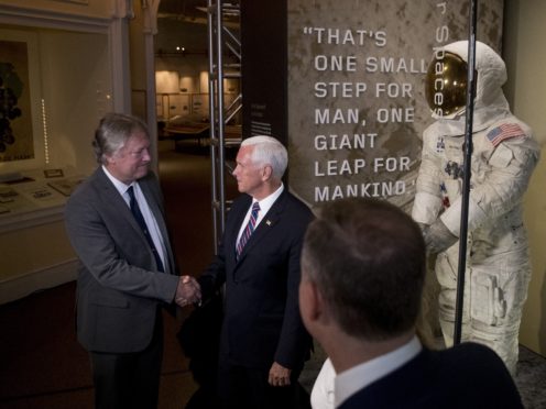 Rick Armstrong, the son of Neil Armstrong, left, and Vice President Mike Pence, right, shake hands after unveiling Neil Armstrong’s Apollo 11 spacesuit at the Smithsonian’s National Air and Space Museum on the National Mall in Washington, Tuesday, July 16, 2019. (AP Photo/Andrew Harnikl)