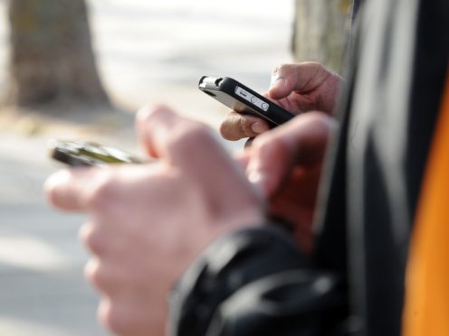 A generic stock photo of people using their mobile phone’s in central London (PA)