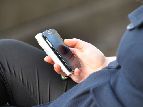 File photo dated 11/10/14 of a person using a mobile phone.