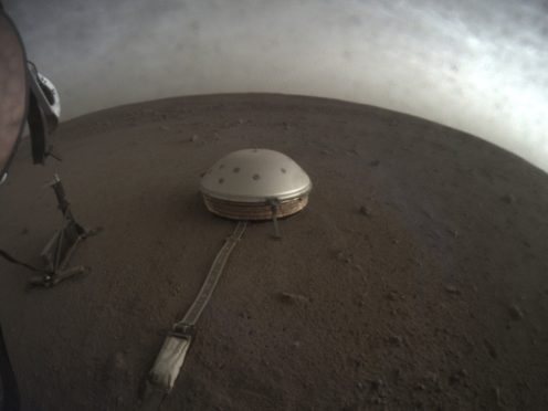 The InSight lander’s dome-covered seismometer, known as SEIS, on Mars (Nasa/JPL-Caltech via AP)